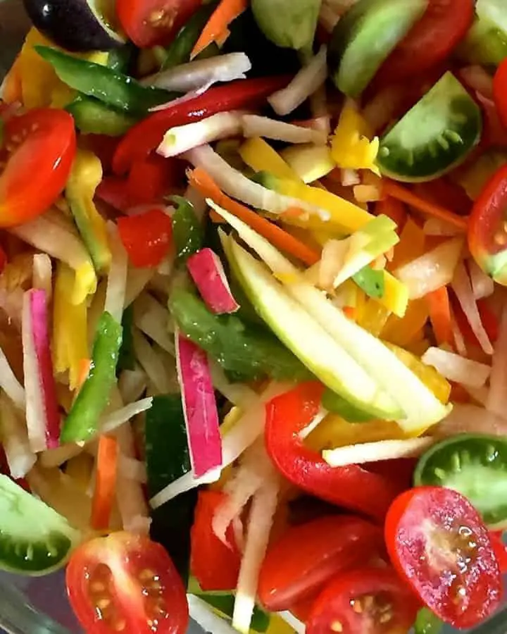 Salad of Radish Tomato Raw Mango in a citrusy ginger dressing