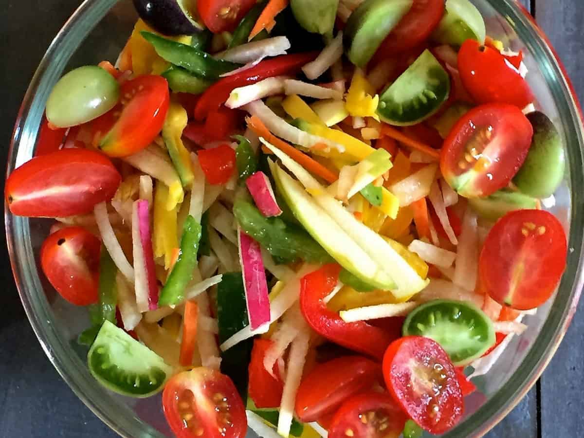 Salad of Radish Tomato Raw Mango in a citrusy ginger dressing