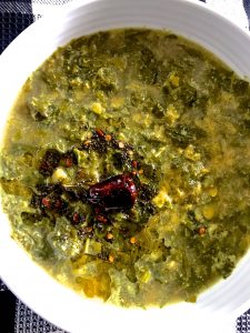 Keerai kootu- South Indian Greens stew with lentils and cumin coconut paste in a white bowl 