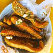 Baked squash liberally crusted with parmesan and herbs.