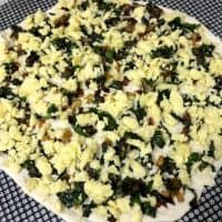Kale and Onion Pizza_spread grated cheese