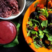 Garnish the Black Rice salad with almonds and raisins