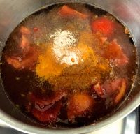 Add tomatoes, spices and curry leaves to the tamarind extract