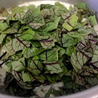 Add sorrel leaves to bean sorrel soup_PepperOnPizza.com