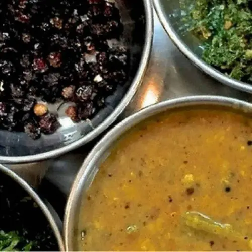 Cooking for the New Mom -Small portions of different dishes including greens and fried berries set on a plate for serving to the new momBaked squash crusted with herbs and parmesan