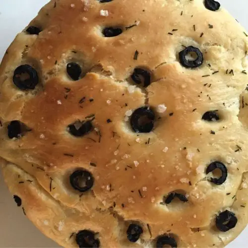 Olive studded focaccia garnsihed with salt and herbs