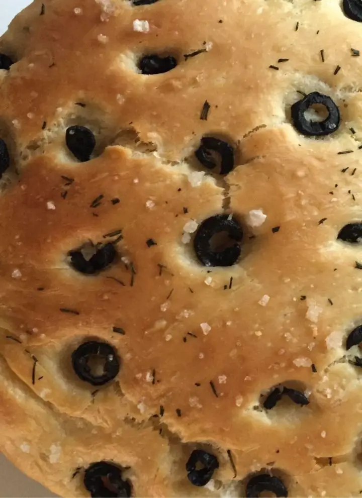 Olive studded focaccia garnsihed with salt and herbs
