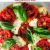 A red green and white pizza from tomato fresh Mozzarella and fresh basil leaves