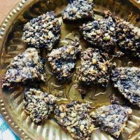 Split Urad dal fritters on brass plate, ready to add to the spinach curry