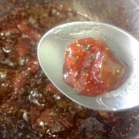 Testing the homemade fig jam for doneness on frozen cold spoon