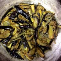 Thinly sliced brijnal with fennel powder and slat, deep fried for the Kashmiri Green Apple Brinjal Curry