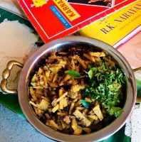 Bamboo shoot curry garnished with coriander leaves and a guide to Karnataka and a book by Mysore based author R K Narayanan alongside