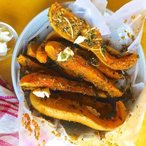 Baked squash liberally crusted with parmesan and herbs.