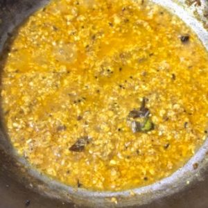 Cook the grated corn in spices till tender