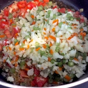 Sauté onions and then add tomatoes, capsicum and the boiled vegetables