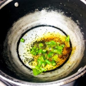 Tempering for the Amti Dal:Turmeric, asafoetida, chillies and curry leaves