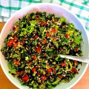 A bowl of levantine tabbouleh, the parsley bulgar tomato salad, on a green checked napkin