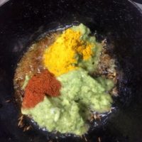 Process Shot: adding green coloured ground mango onion paste and turmeric, chili powder for sauteeing