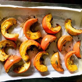 Process Shot 2: Place the marinated pumpkin slices on a greased parchment sheet lined baking sheet, and bake at 220 C for 20 minutes
