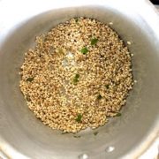 Process 1: Pear barley and curry leaves being sauteed inside a pressure cooker