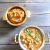Golden brown Thiruvathirai Ezhukari Kootu /stew and Kali/ sweet in 2 brass bowls on a grey wooden background. https://www.pepperonpizza.com