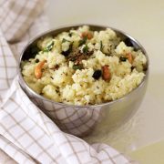 Bowl of well cooked rice and lentils. Hot savoury ven pongal tempered in ghee with cumin and pepper and garnished with cashew.