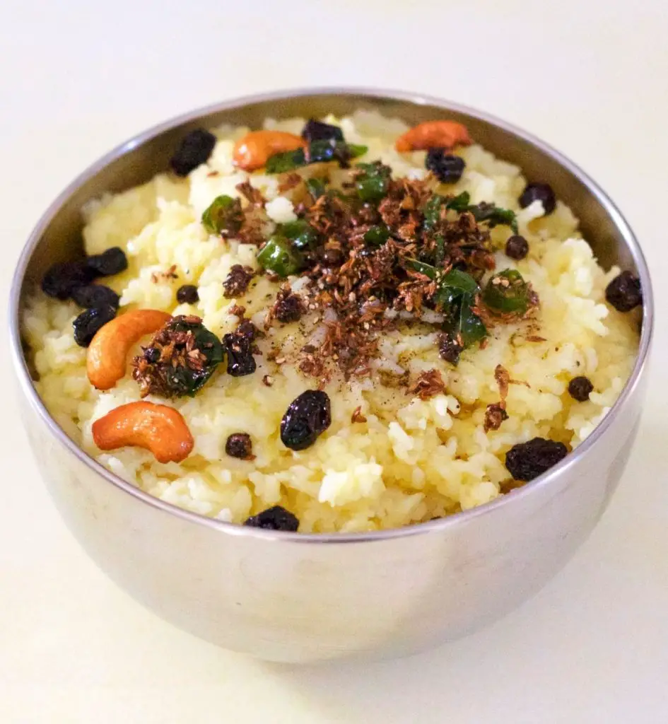 Cooked Rice and split moong lentils garnished with fried cashew and raisins and tempered with cumin, pepper, ginger and curry leaves